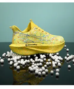 Chaussures de marathon professionnelles jaunes à plaque de carbone et motif éclaboussé