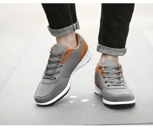 Macro view of men's grey and brown casual walking shoes with soft white soles