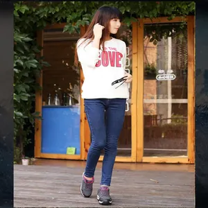 Outdoor lifestyle shot of gray and pink hiking sneakers worn by a female model
