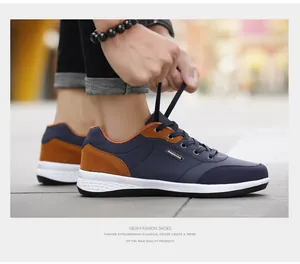 Close-up of men tying laces on navy blue casual sports walking shoes outdoors