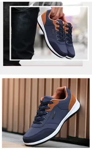 Detail of navy blue and brown men's casual walking shoes with soft anti-slip white soles.