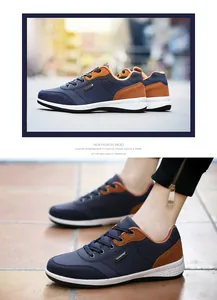 Detailed view of navy blue men's walking shoes with brown suede accents and white soles