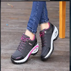 Close-up detail of black and pink women's hiking sneakers featuring thick air cushion soles