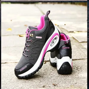 Close-up of grey and pink women's outdoor hiking shoes with visible air cushion sole