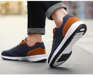 Detail of men's navy and brown walking shoe with anti-slip soft sole