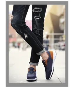 Casual navy blue men's walking shoes featuring soft white soles and stylish brown accents.