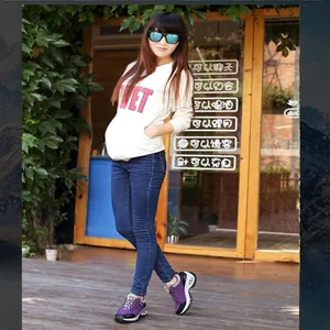 Lifestyle detail showing purple outdoor hiking shoes worn by a model in casual setting