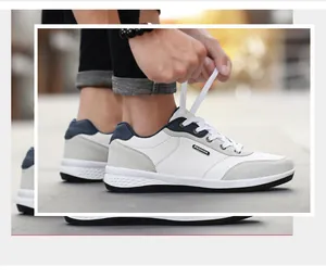 Detail view of men's casual white walking shoes being tied in a lifestyle setting