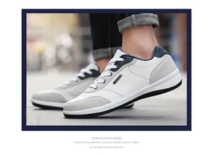 Detail view of men's casual white sneakers with soft sole and stylish grey accents.