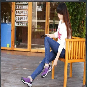 Asian woman wearing purple outdoor hiking sneakers in a casual lifestyle setting