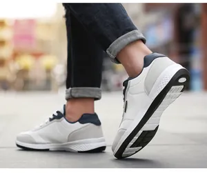 Close-up of men's white casual walking shoes with non-slip sole shown in walking motion.