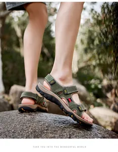 Detailed view of men's olive green genuine leather outdoor sandals on a rocky surface outdoors