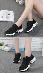 Detail of women's black mesh breathable sports shoes with visible air cushion sole