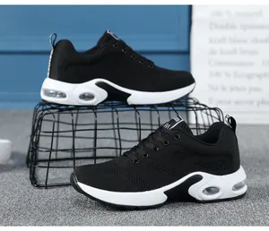 Black women's breathable mesh running sneakers with white air cushion soles view