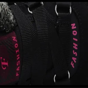 Detailed view of black winter sports shoe showing laces and pink Fashion embroidery