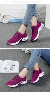 Detailed close-up of purple women's lightweight running sneakers with air cushion soles.