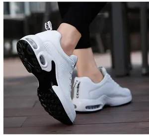 Detailed view of white breathable mesh sneakers with integrated air cushion sole.