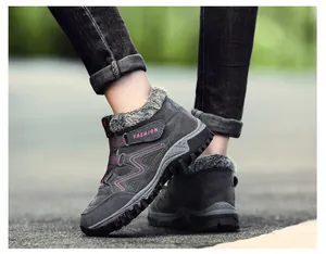 Detail view of grey winter outdoor sneakers with pink fashion logo and fur lining