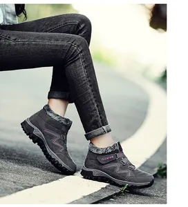 Close-up detail of grey outdoor winter boots featuring warm plush lining and velcro strap