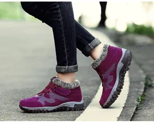 Detail of purple winter boots featuring warm faux-fur lining and rugged non-slip soles.