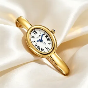 Macro shot of an elegant oval bangle watch with gold finish and Roman numerals