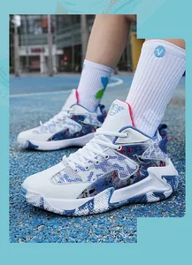 Side view of white and blue basketball shoes with graphic print on an outdoor court