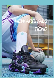 Action shot of black basketball shoes with purple and teal patterns on court