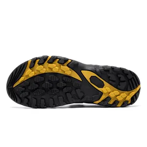 Non-slip rubber sole of men's leather beach sandals with yellow and black tread pattern.