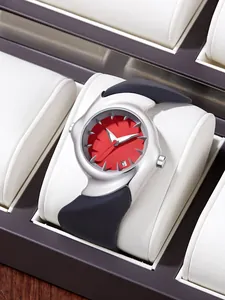 Detail of futuristic Y2K distorted watch with red dial and silver asymmetric case.