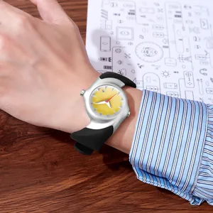 Close-up of y2k aesthetic distorted silver quartz watch with yellow dial on a wrist.