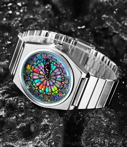 Macro view of silver stainless steel quartz watch featuring a colorful stained glass dial