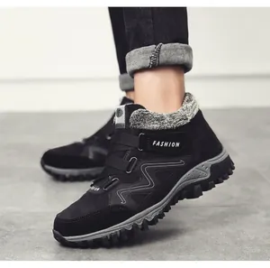 Close-up of men's black fleece-lined winter boots with anti-slip rubber soles.