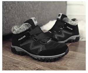 Detailed side view of black men's winter snow boots featuring warm plush lining and secure velcro straps.