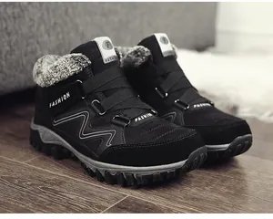Detailed view of black men's winter boots featuring warm grey faux fur lining and sturdy soles.