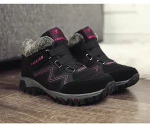 Macro detail of black winter outdoor boots featuring thick plush fur lining and pink accents