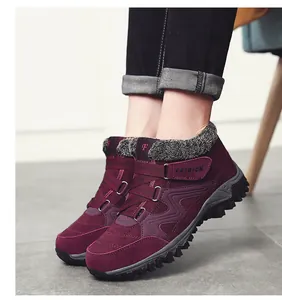 Detailed view of burgundy fleece-lined winter outdoor boots with velcro straps