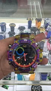 Macro detail of the SMAEL rainbow men's sports watch with gold plating held in hand