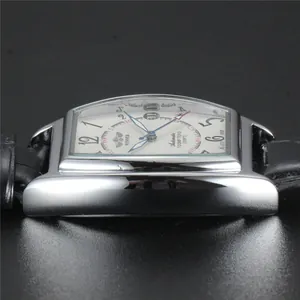 Side view detail of WINNER silver tonneau automatic mechanical watch with black leather strap