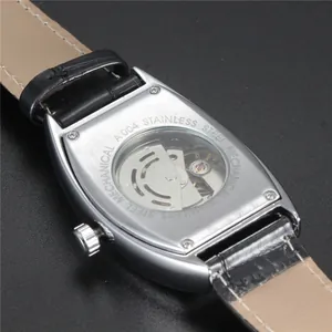 Exposed mechanical movement on the back of a tonneau-shaped stainless steel watch