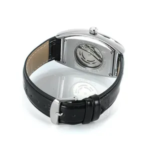 Close-up detail view of the mechanical movement and black leather strap of a tonneau watch