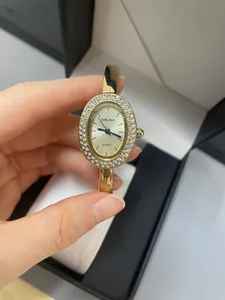 Elegante reloj de pulsera SUNLIFEX para mujer ovalado dorado con bisel de diamantes