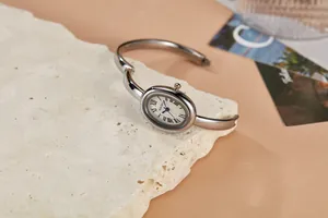 Elegante close-up van een zilveren ovale armbandhorloge op een natuurstenen plaat