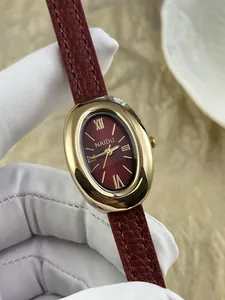 Detailopname van elegant ovaal vintage dameshorloge met bordeauxrode lederen band