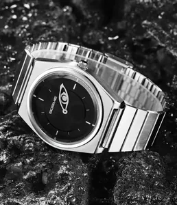 Macro detail of a silver stainless steel quartz watch featuring a unique eye design dial