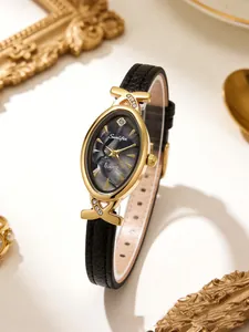 Close-up of an elegant oval ladies' watch with black leather strap and marble dial