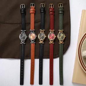 Close-up detail of elegant oval quartz watches with slim leather straps in multiple colors