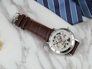 Close-up of FORSINING skeleton mechanical watch with Roman numerals and leather strap