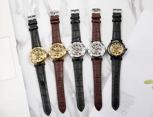 Detailed view of mechanical skeleton watches with Roman numerals and leather straps