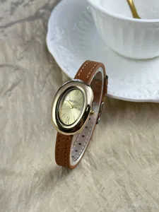 Detailweergave van een vintage ovaal dameshorloge met bruine leren band en gouden kast.