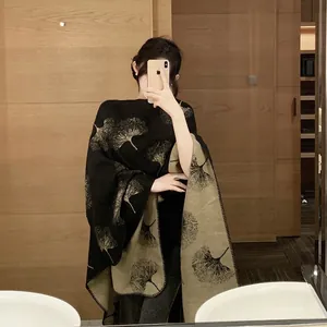 Detail view of faux cashmere knit shawl with ginkgo leaf pattern in mirror selfie